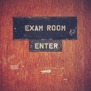 Retro Filtered Image Of A Grungy Exam Room Door At A Public School In The USA