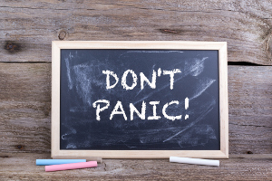 DON'T PANIC! Text on blackboard