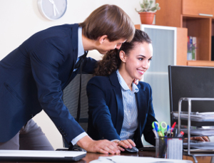 Boss touching subordinate employee in office